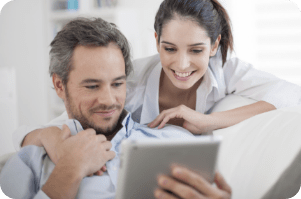 Man and Woman looking at tablet